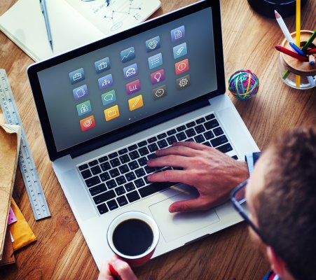 features mackeeper mac utililtiies software features man with glasses and coffeee cup in hand on mac computer apps on monitor